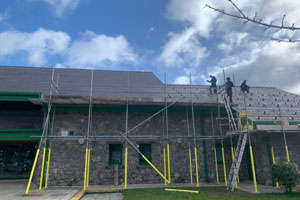 Photovoltaic solar panels being installed on the roof of Glasdir Primary School, Ruthin, Wales.