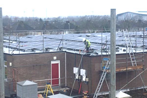 Photovoltaic solar panels being installed on the roof of Lliswerry Primary school, Newport, Gwent.